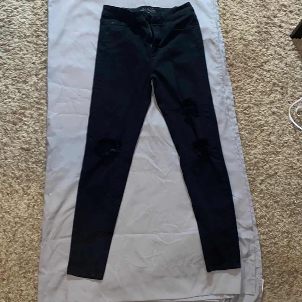 Black ripped at the knees jeans size 4 worn one time, washed once.